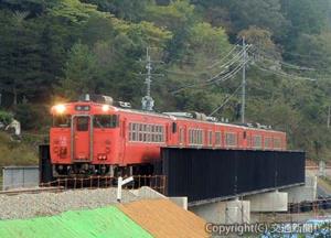 架け替えられた第１三篠川橋りょうを通過する上り列車（２３日午前）