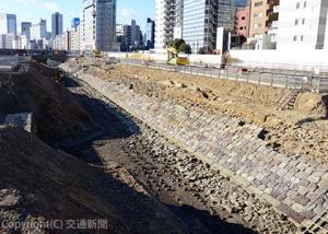 盛土の斜面の一部に石積みが残る高輪築堤跡