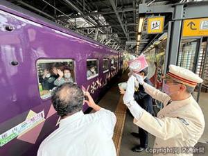 田村駅長（右）らに見送られて発車する「花たび　そうや」初列車＝旭川駅＝