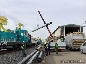 鉄道・運輸機構から支援を受けた鋼管柱を保守用車へ積み込む（ＪＲ東日本提供）