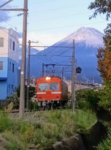 雪化粧の富士山を背景に吉原―ジヤコト前間を走行する岳南電車の車両