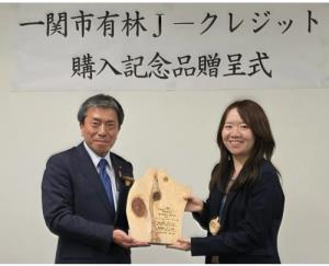 佐藤善仁市長＝写真左＝から同市産の杉を使用した記念品が贈呈（観光経済新聞提供）