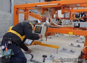 北海道新幹線での軌道スラブ据え付け作業（コントローラーによる調整）の様子＝鉄道建設・運輸施設整備支援機構提供＝